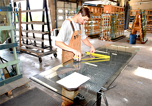 Employee measuring glass for a template.